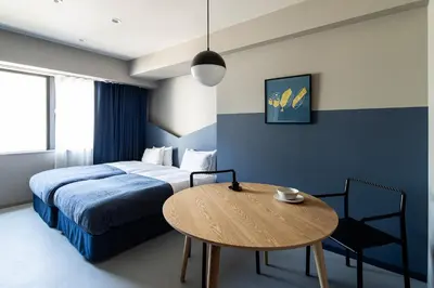 a hotel room with a bed and a table at Section L Tsukiji in Tokyo