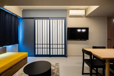 a room with a bed and a table and a window at Section L Tsukiji in Tokyo