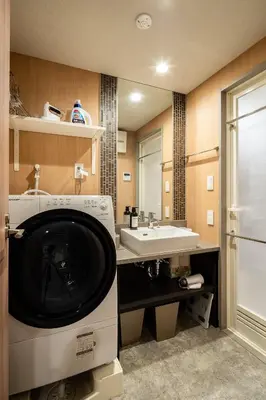 a bathroom with a sink and a washing machine at Section L Kuramae - Asakusa in Tokyo
