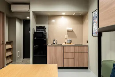 a small kitchen with a counter and a refrigerator at Section L Kuramae - Asakusa in Tokyo