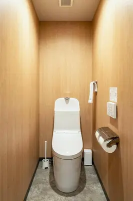a bathroom with a toilet and a toilet paper dispenser at Section L Kuramae - Asakusa in Tokyo