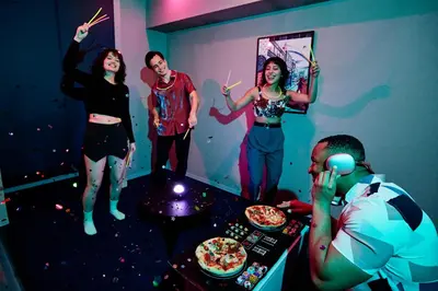 a group of people standing in a room with pizza at Section L Kuramae - Asakusa in Tokyo