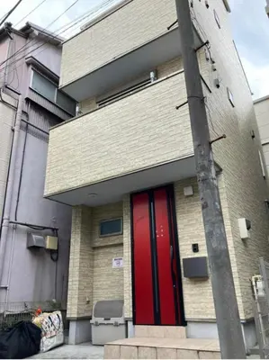 a building with a red door on the side of it at One-Ikebukuro TS0230 in Tokyo
