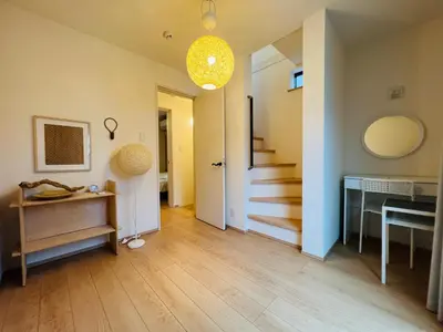 a living room with a hallway with a table and stairs at One-Ikebukuro TS0230 in Tokyo