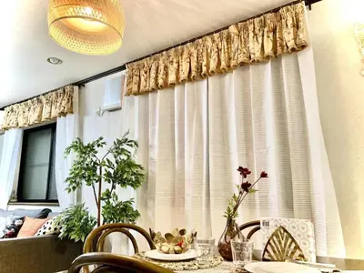 a dining room table with a window with curtains at Ikebukuro Sta 8 mins Good Access Modern House TS0318 in Tokyo