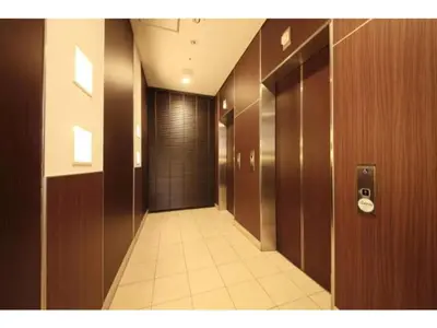 a hallway in a building with wooden walls and a door at R & B Hotel Kamata Higashiguchi - Vacation STAY 38814v in Tokyo