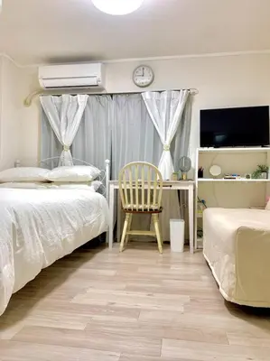 a bedroom with two beds and a chair and a desk at COCO Nakameguro 202 in Tokyo