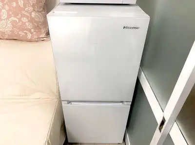 a white refrigerator sitting next to a bed at COCO Nakameguro 202 in Tokyo