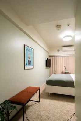 a bedroom with a bed and a table at Section L Hamamatsucho in Tokyo