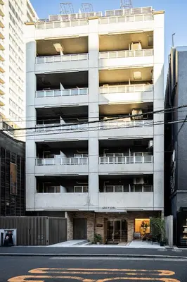 an apartment building with balconies on the side of a street at Section L Hamamatsucho in Tokyo