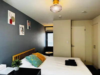 a bedroom with a large white bed in a room at Lucky you! YOTSUYA in Tokyo