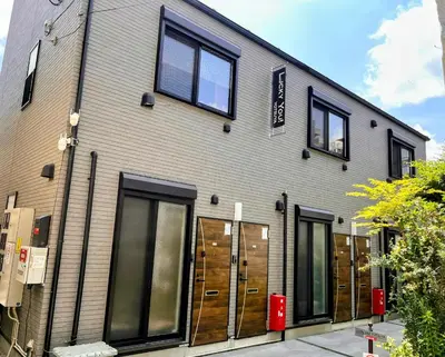 a building with windows and doors on a street at Lucky you! YOTSUYA in Tokyo