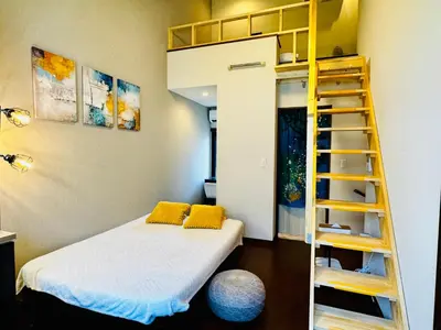 a bedroom with a bunk bed and a ladder at Lucky you! YOTSUYA in Tokyo