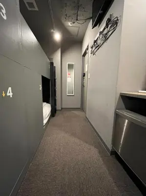 a room with a hallway with a bed and a hallway sidx sidx at Rhodes Otsuka Hotel in Tokyo