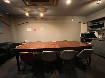 a conference room with a large wooden table and chairs at Rhodes Otsuka Hotel in Tokyo