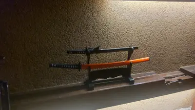 an orange knife on a shelf on a wall at Guest House Tokyo Samurai in Tokyo