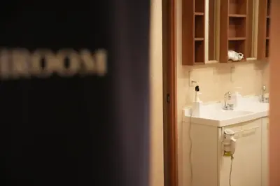 a bathroom with a sink and a mirror at Guest House Tokyo Samurai in Tokyo