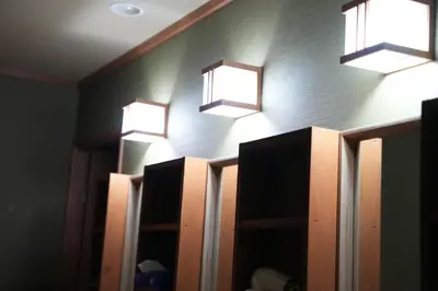 a bathroom with three lights on a wall at Guest House Tokyo Samurai in Tokyo