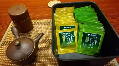 a tea pot and packets of chopsticks and a candle at Guest House Tokyo Samurai in Tokyo