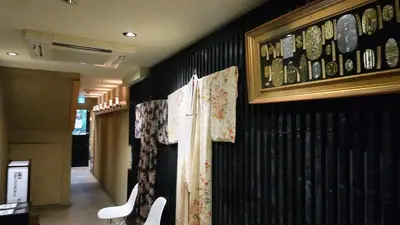 a room with a wall with china on it at Guest House Tokyo Samurai in Tokyo