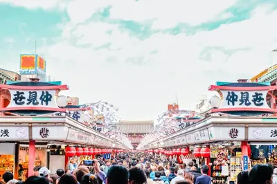a crowd of people walking through a market at OMO3 Asakusa by Hoshino Resorts in Tokyo