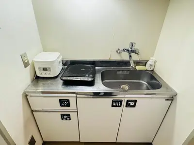 a kitchen counter with a sink and a microwave at Kabukicho-503-SJ0010 in Tokyo