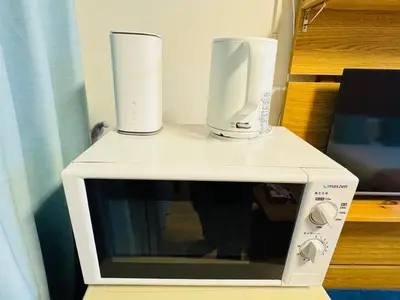 a microwave with two cups on top of it at Kabukicho-503-SJ0010 in Tokyo