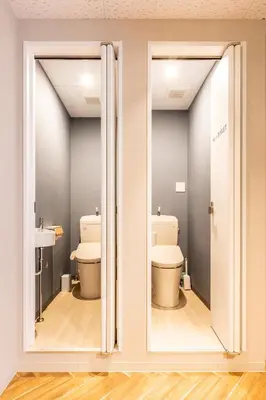 a bathroom with two toilets and a window at Akasaka The Hostel in Tokyo