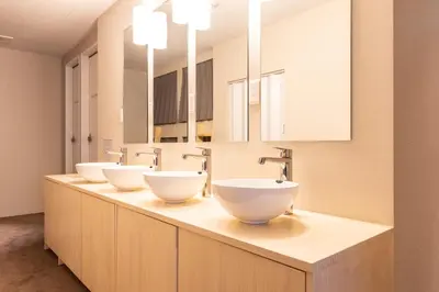a row of three sinks in a bathroom at Akasaka The Hostel in Tokyo