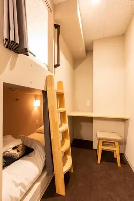 a dorm room with a bunk bed and a desk at Akasaka The Hostel in Tokyo