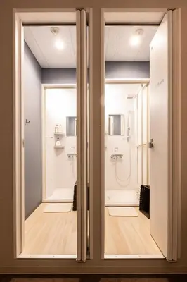 a bathroom with two sliding doors and a shower at Akasaka The Hostel in Tokyo