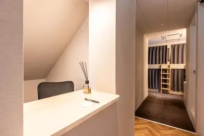 a room with a desk and a chair in a room at Akasaka The Hostel in Tokyo