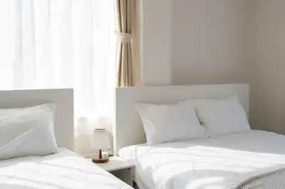 two white beds in a bedroom with a window at ILIMA Higashi Nakano - Vacation STAY 89505v in Tokyo