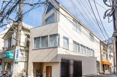 a white building on the corner of a street at ILIMA Higashi Nakano - Vacation STAY 89505v in Tokyo