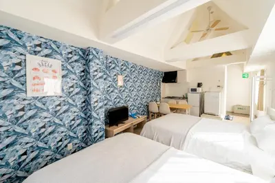 two beds in a room with blue and white wallpaper at ILIMA Higashi Nakano - Vacation STAY 89505v in Tokyo