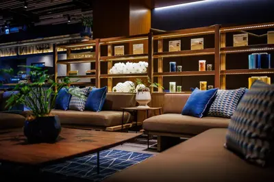 a lobby with couches and a table with blue pillows at &Here TOKYO UENO in Tokyo