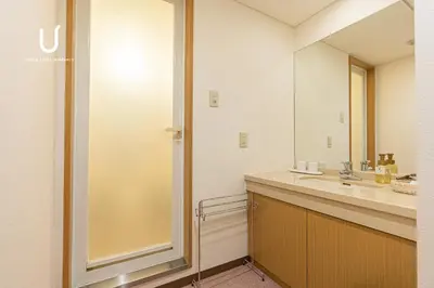 a bathroom with a sink and a mirror at Forest Hongo by unito in Tokyo