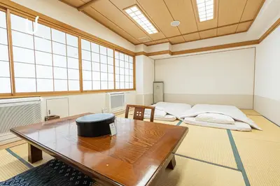 a large room with two beds and a table at Forest Hongo by unito in Tokyo