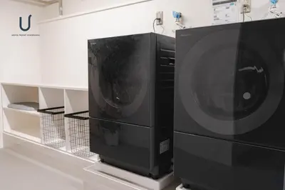 two washing machines sitting next to each other at Forest Hongo by unito in Tokyo