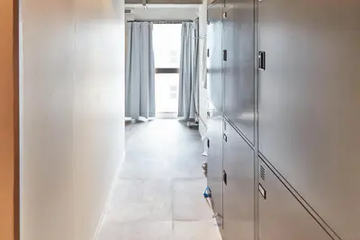 a hallway with white cabinets and a window at Tora Hotel Asakusa in Tokyo