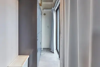 a hallway with a window and a white hallway with a hallway at Tora Hotel Asakusa in Tokyo