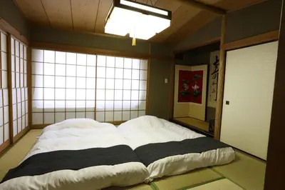a large bed in a room with a large window at Oyado Tsuki to Kawa in Tokyo