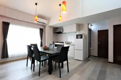 a kitchen and dining room with a table and chairs at Oyado Tsuki to Kawa in Tokyo