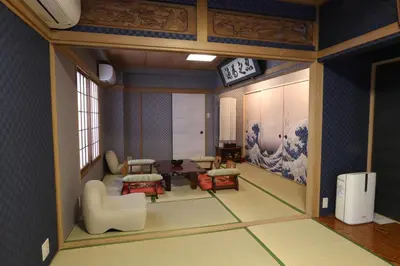 a rendering of a living room with chairs and a table at Oyado Tsuki to Kawa in Tokyo