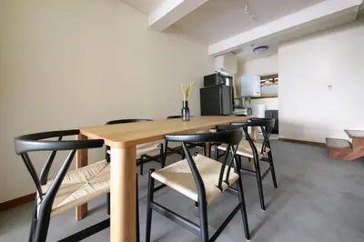 a dining room with a wooden table and black chairs at \u3077\u3075\u304b\u4e21\u56fd\u3000\uff08pufuka Ryogoku) in Tokyo