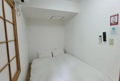 a small room with a white bed in it at Hostel Belle Via Tokyo in Tokyo