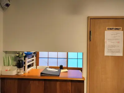 an office with a desk with a sign that reads staff only at Hostel Belle Via Tokyo in Tokyo