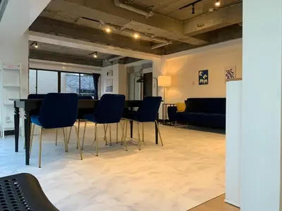 a living room with a table and chairs at Spacious studio(62m2) in western Shinjuku in Tokyo
