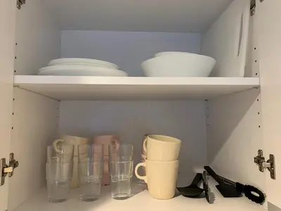 a shelf with cups and plates and glasses on it at Spacious studio(62m2) in western Shinjuku in Tokyo