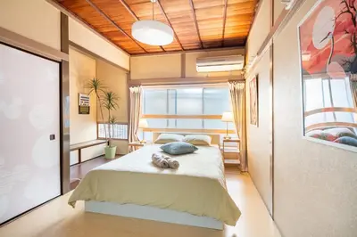 a bedroom with a bed with two stuffed animals on it at North Shinjuku house 5\u99c5\u5f92\u6b69\u570f\u5185\u306e\u5317\u65b0\u5bbf\u306e\u5bb6 in Tokyo